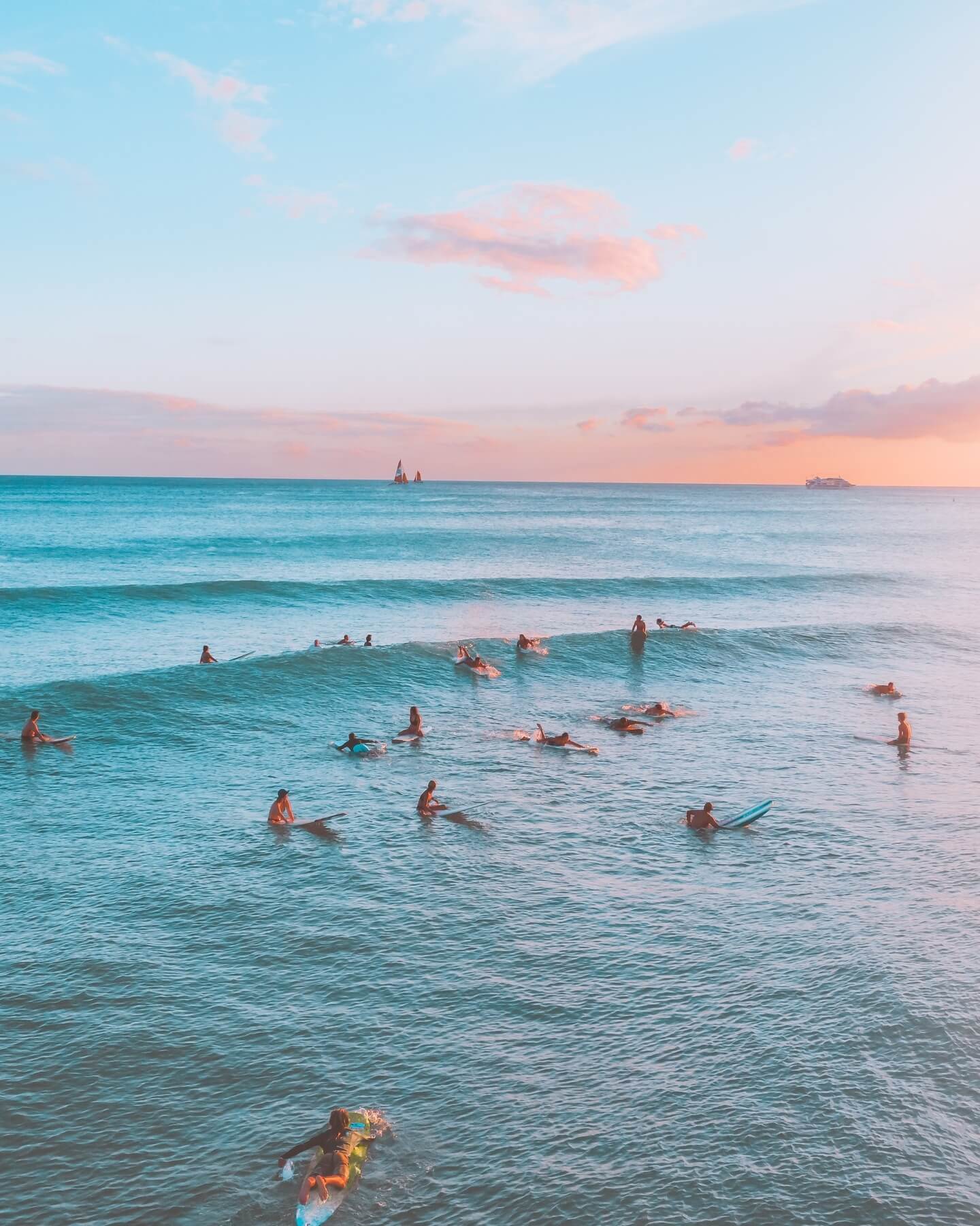 Waikiki at sunset with surfers