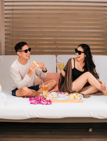 Couple enjoying a meal at the cabana at Halepuna