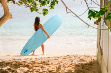Woman holding a surfboard at Waikiki Beach