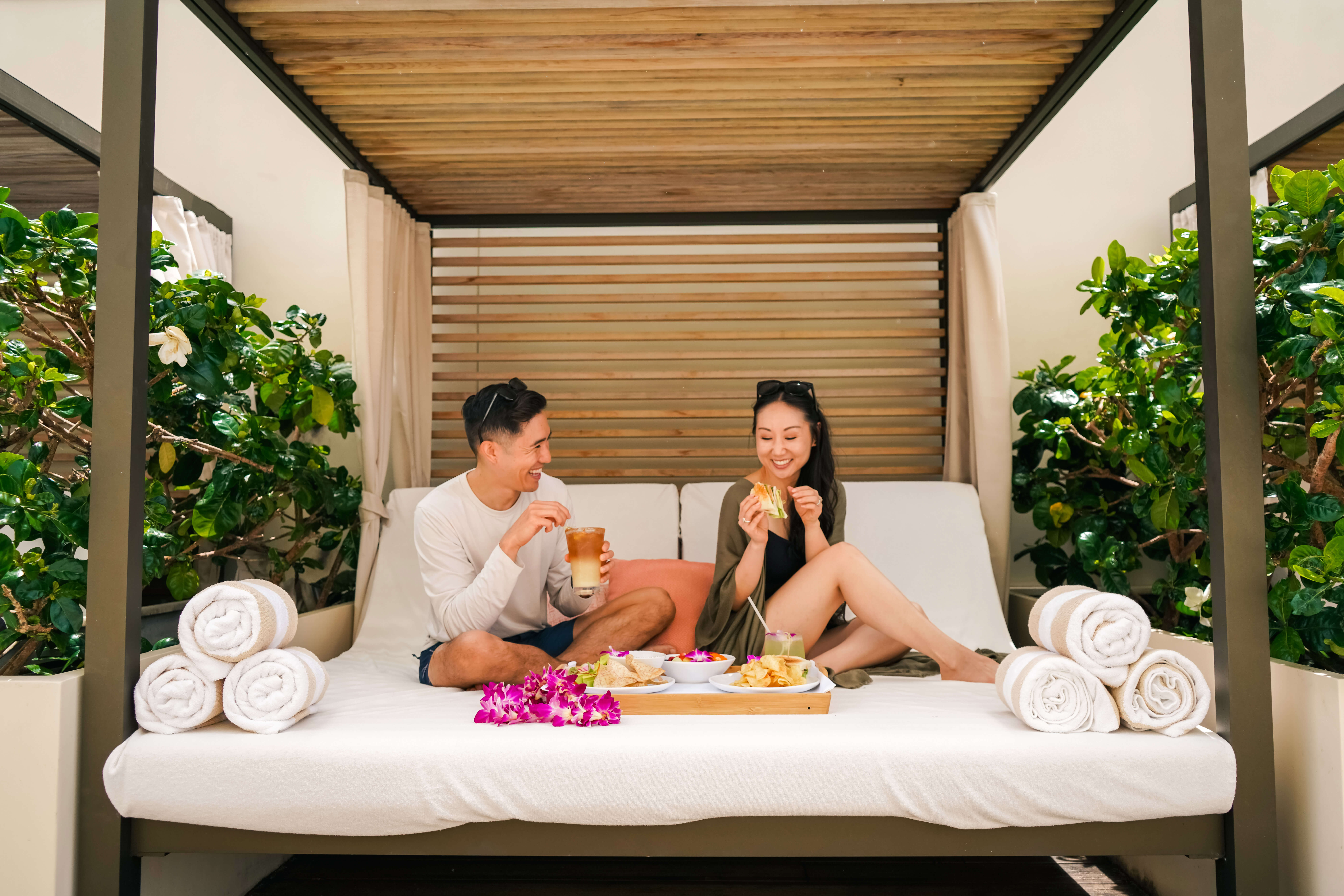 Couple Enjoying poolside cabana at Halepuna